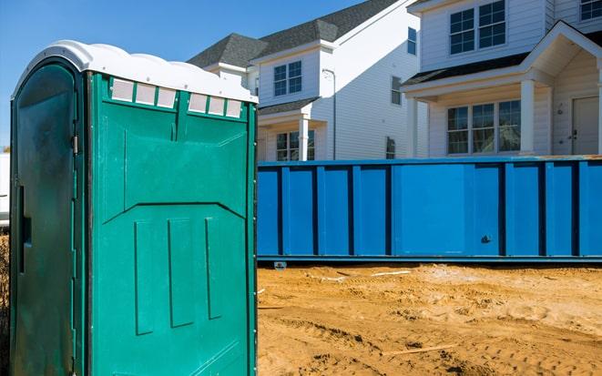dumpster and portable toilet at a construction site in Peabody MA